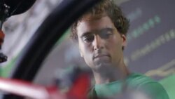 Young bike mechanic spins and stops bicycle wheel in workshop Stock Footage