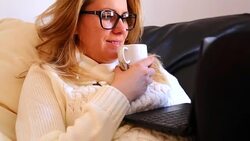 Woman with a laptop and a cup of coffee Stock Footage