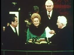 First Lady Pat Nixon holds the bible while her husband, Richard M. Nixon, takes the oath of office from Chief Justice Warren E. Burger on January 20, 1973, for his second term as U.S. President. News Clip