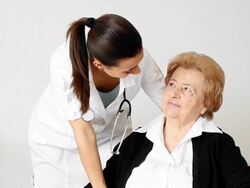 Young female nurse with her senior female patient. Stock Footage