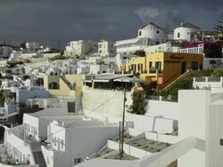 WS PAN White building in town located on cliff / Fira, Santorini, Greece Stock Footage