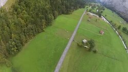 POV parachuting after base jump landing in farmers field Stock Footage