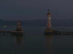 WS View of Lindau harbour entrance and lighthouse at night on Lake Constance / Lindau, Bavaria, Germany  Stock Footage