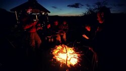 Relaxing near campfire Stock Footage