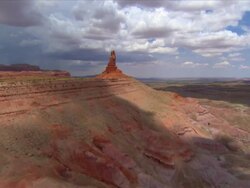 Aerial past 'Owl Rock' rock formation / near Monument Valley Stock Footage