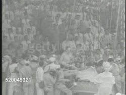 1946: TREATY OF MANILA: ** VS Crowds of Philippine people & General Douglas MacArthur at ceremony in Manila, Philippines, MacArthur speaking (SOT), '... a new nation is born.... in the struggle of the people...' Philippine Independence Instructional Video