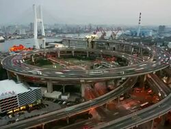 Time lapse high angle wide shot traffic on Nanpu Bridge spiral / day to night / Shanghai Stock Footage