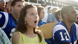 Anxious stadium crowd cheers at football game, jumps to feet Stock Footage
