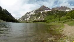 Crater Lake right next to the Maroon Bells looking up at the Amazing Elk Mountains Timelapse Stock Footage
