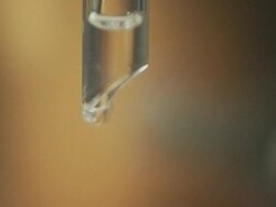 ECU, SELECTIVE FOCUS, Water droplets dripping from glass tube Stock Footage