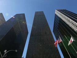 WS PAN LA Shot of sun and waving American flag and Japanese flag at skyscraper of 6th Avenue / New York, United States Stock Footage