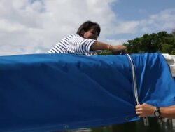 CU couple removing sail cover on yacht /tampa,florida,USA Stock Footage