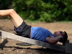 A man doing sit-ups at a park. - Slow Motion Stock Footage