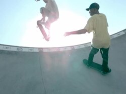 MS SLO MO LA Shot of two skateboarders riding side of skate park bowl, one jumping over other in air / Venice, California, United States Stock Footage