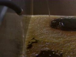 ECU of rum distilling in tank. Stock Footage