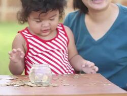 Cute boy with mother learn to count money Stock Footage