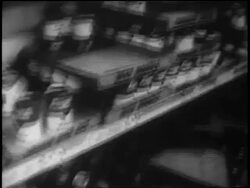 B/W 1962 close up tilt down grocery store shelves with few cans of soup left during Cuban Missile Crisis Stock Footage