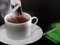 MS Tea bag floating on hot water in teacup / Los Angeles, California, United States Stock Footage