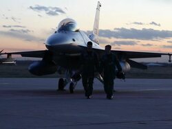 WS F-16 pilots walking away from an F-16 fighter jet at sunset, Aurora, Colorado, USA Stock Footage
