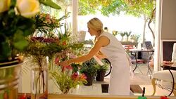 Florist with clipboard checking inventory in flower shop Stock Footage