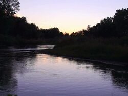 Super slow motion shot of river at sunset wide. Stock Footage