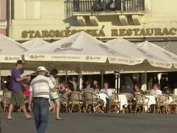 Wide Shot static-Pedestrians pass an outdoor cafe in a town square. / Prague, Czech Republic Stock Footage