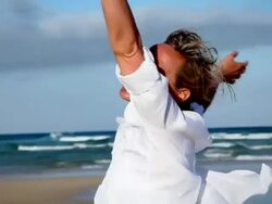 Woman spinning on beach Stock Footage
