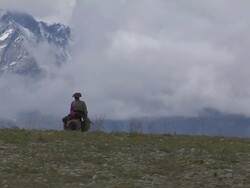 Long shot man riding a horse Taklakot Tibet China Stock Footage