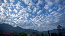 Time lapse of clouds moving at sunset Stock Footage