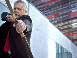 HD DOLLY: Businessman Aiming With A Bow Stock Footage