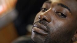 Man closes eyes, stares into and away from camera as barber trims his beard and moustache Stock Footage