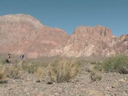 Couple mountain biking towards camera in rocky terrain Stock Footage