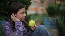 little girl eat green apple Stock Footage