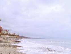 WS ZI reactors and cooling towers of nuclear power plant behind sea wall at San Onofre State Beach /Pendleton, California, USA Stock Footage