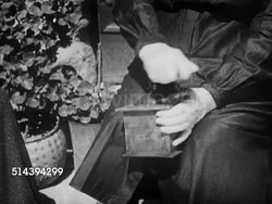1950: BEAULIEU: DORDOGNE VALLEY: VS Villagers walking & working on street, female sitting outdoors grinding coffee, male w/ beret talking, female pumping water, women washing clothes in large pool. France, country, rural, lifestyle Instructional Video
