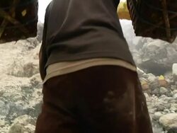 MS Man climbing the Ijen volcano crater carrying sulfur / Ijen, Java, Indonesia Stock Footage