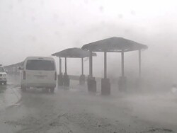 Large waves crash over sea wall toward vehicles as typhoon Megi or Juan hits coast, NE Luzon, Philippines Oct 2010 / AUDIO Stock Footage