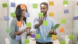 Business people looking at adhesive notes in conference room Stock Footage