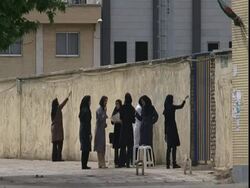 Group of scarved women painting wall, Iran (sound available) Stock Footage