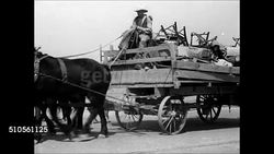 1937: FARM FAMILY MOVING: HD: LA WS Male driving horse drawn wagon loaded w/ belongings, furniture, family. Family loading up truck w/ sign 'California or Bust', Dust Bowl refugees, man changing tire on trailer w/ 'No More Dustbowl' painted on back. Instructional Video