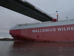 WS T/L Massive container ship passing under vast span of Westgate Bridge crossing Yarra River / Melbourne, Victoria, Australia Stock Footage