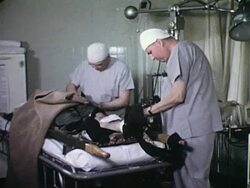 Nurses attending to patient with abdomen wound Stock Footage