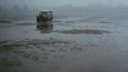1969 MONTAGE Land Rover and workers distributing water markers along the beach on Pegwell Bay / Ramsgate, Kent, England Stock Footage