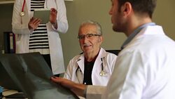 Professor and assistant doctor examine an x-ray film Stock Footage