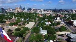 Aerial Over East Austin Close fly by Texas Flag towards downtown Texas capital city Stock Footage