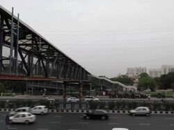 A footbridge for pedestrians to cross over the National Highway 8, Delhi to Mumbai at Udyog Vihar, Gurgaon, Haryana Stock Footage