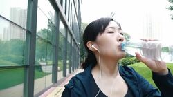 Sporty young woman drinking water Stock Footage