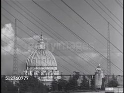 1940: VATICAN CITY: RADIO: HA WS Power lines w/ radio tower & Basilica tower BG. TU Radio tower w/ banana plant leaves FG. HA WS Building w/ radio tower BG. Instructional Video