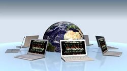 A globe of the Earth revolves in the middle of several laptops on a circular desk. Stock Footage