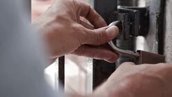 Gates being padlocked & secured, close up CO Stock Footage